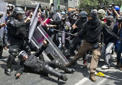 Demonstrators clash with riot police during a protest on September 1, 2013, in Mexico City.