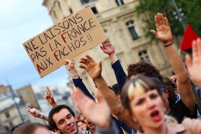 People gather to protest against the French far-right Rassemblement National party, at Place de la Republique following partial results in the first round of the early 2024 legislative elections, in Paris, France, June 30, 2024. The slogan reads "Let's not leave France to the fascists."
