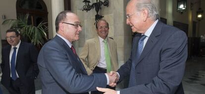 El gobernador del Banco de España, Luis María Linde, (i) saluda al presidente ejecutivo del banco BMN, Carlos Egea Krauel (d)