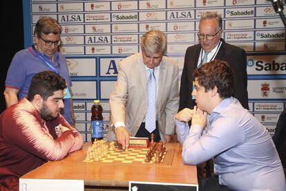 El rector de la Universidad de León, Juan Francisco García Marín, realiza el saque de honor de la segunda semifinal. A su derecha, el director de la organización del torneo, Marcelino Sión; a su izquierda, el árbitro, Joaquín Espejo.
