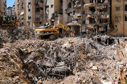 Rescue workers search through the rubble for possible victims of Israel's bombing of Beirut on Monday.