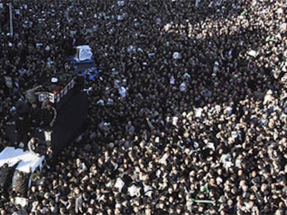 Un coche traslada entre la multitud el féretro del gran ayatolá iraní, Hosein Ali Montazerí.
