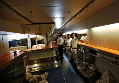 People take pictures inside the parked high speed Talgo train during its trial run at a railway station in Mumbai