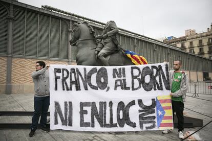 Joves independentistes llueixen una pancarta en contra de l'exhibició de l'estàtua i d'altres símbols del franquisme.