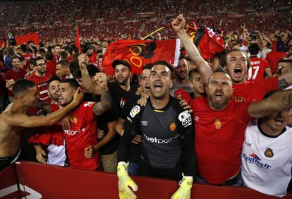 El portero del RCD Mallorca, Manolo Reina, celebra el ascenso de su equipo junto a aficionados en el esadio de Son Moix.