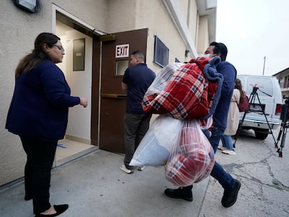 Voluntarios llevan cobijas a una iglesia católica en Los Ángeles (California) que recibió a 42 migrantes trasladados desde McAllen (Texas), el 14 de junio.