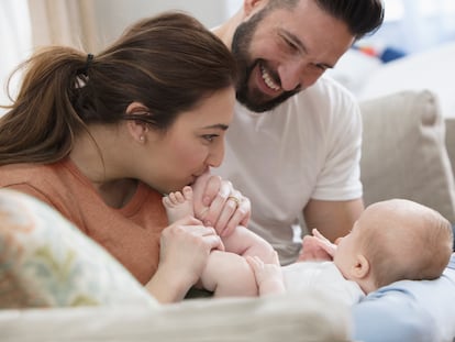 Young family having fun with their new born baby