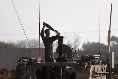 An Israeli soldier loads a guided mortar munition system at an area near the border with the Gaza Strip, in southern Israel, January 1, 2024.