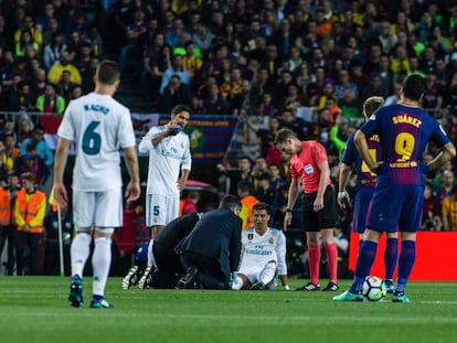 Cristiano se duele del tobillo en el césped del Camp Nou.