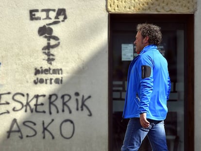 Un hombre camina junto a un grafiti de ETA, este viernes en Oiartzun (País Vasco).
