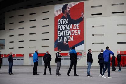 People wait in line to be vaccinated outside the Wanda Metropolitano stadium in Madrid at the end of February.