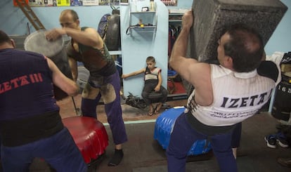 Izeta I trata de culminar la alzada con una piedra rectangular, la que se utiliza para levantar el máximo de kilos. El pequeño Jakes, en el centro, no se pierde ningún entrenamiento.