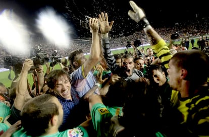 Los jugadores del Barcelona celebran su triunfo mojándose con Champagne mientras los fotógrafos intentan captar el momento.