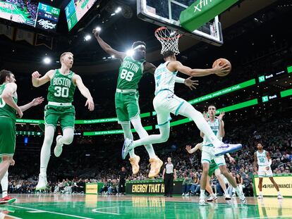 Neemias Queta defends the backboard for the Charlotte Hornets in a game in Boston, Massachusetts, on April 12.