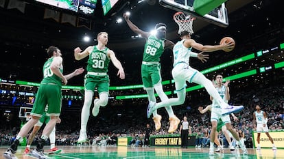 Neemias Queta defends the backboard for the Charlotte Hornets in a game in Boston, Massachusetts, on April 12.