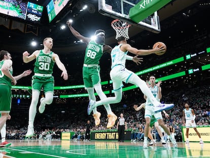 Neemias Queta defends the backboard for the Charlotte Hornets in a game in Boston, Massachusetts, on April 12.