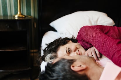 Loving mature couple in a hotel bed.