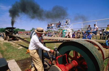 A man tests a steam engine at a festival in the US.