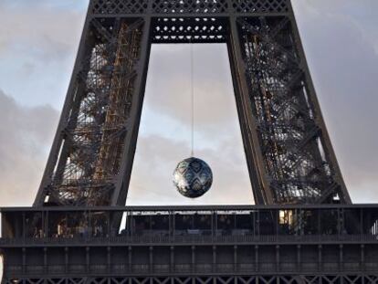 Una esfera cuelga entre el primer y el segundo piso de la torre Eiffel en París, con motivo de la COP21. 