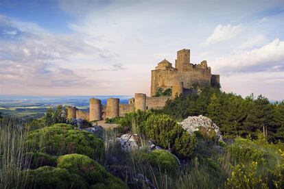 Un castillo: Loarre (Huesca). Las fortalezas y castillos son la seña de identidad de muchísimos pueblos españoles y su principal reclamo turístico. Una agitada historia de invasiones y ocho siglos de batallas y de fronteras cambiantes han dejado como herencia fortalezas tan impresionantes como el castillo románico de Loarre, donde se rodó 'El reino de los cielos', de Ridley Scott. Le siguen en popularidad otros de estilos completamente diferentes, como el Alcázar de Segovia, más palaciego y urbano; el misterioso castillo de Cardona, en Barcelona; o el escenográfico castillo de Butrón (Bizkaia).