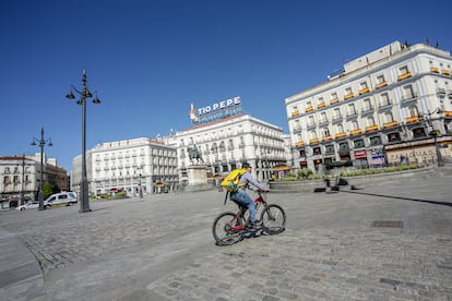 Un 'rider' de Glovo circula por la Puerta del Sol el 4 de abril.