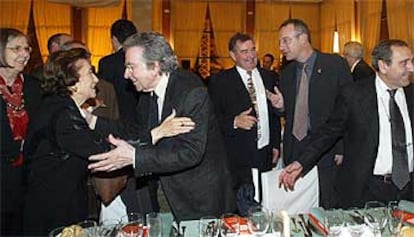 Los premiados María de la Font Carulla y Antonio Tàpies se saludaron anoche, en la cena de los Octubre, junto a Eliseu Climent (derecha).