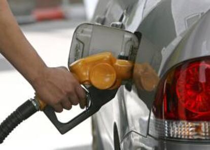 Un trabajador llena el depósito de un coche en una gasolinera. EFE/Archivo