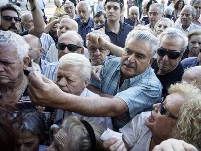 Pensionistas aguardan su turno ante una sucursal bancaria en Atenas.