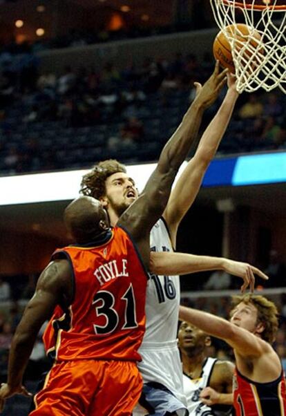 EL español Pau Gasol (derecha) entra a canasta ante la defensa de Adonal Foyle, de los Golden State Warriors.