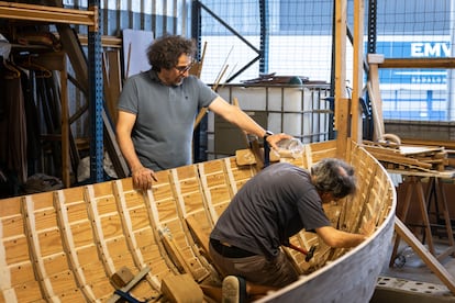 Miembros de la asociación Aixa trabajan en una embarcación tradicional de madera, en su taller de Badalona.
