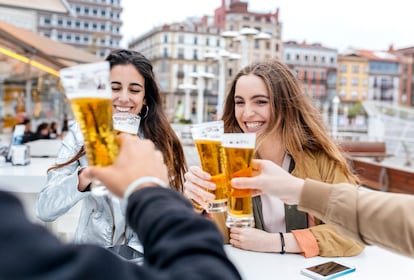 Gijón, Asturias, Spain, group of friends toasting with beer