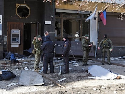Policías y miembros prorrusos junto a los cuerpos de varios civiles tras un bombardeo en la ciudad de Donetsk, este lunes.