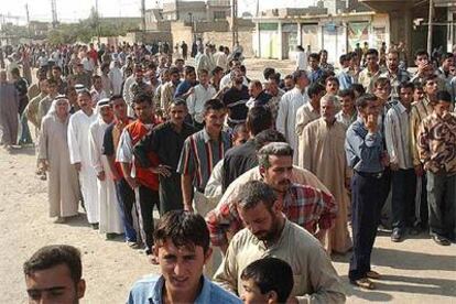 Colas de votantes ante un colegio electoral de Mosul (norte de Irak), en el referéndum constitucional celebrado ayer.