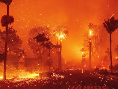 The Palisades Fire ravages a neighborhood amid high winds in the Pacific Palisades neighborhood of Los Angeles, Tuesday, Jan. 7, 2025. (AP Photo/Ethan Swope)