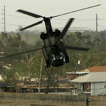 Un helicóptero militar recoge sacos de arena para atajar las inundaciones en Nueva Orleans.