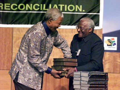 El presidente de la Comisión para la Verdad y la Reconciliación en Sudáfrica, el arzobispo Desmond Tutu (derecha), entrega al presidente del país, Nelson Mandela, el informe de la citada comisión sobre las violaciones de los derechos humanos durante 30 años de 'apartheid', en 1998.