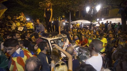 A woman stands on a police car at the protest on September 20, 2017.