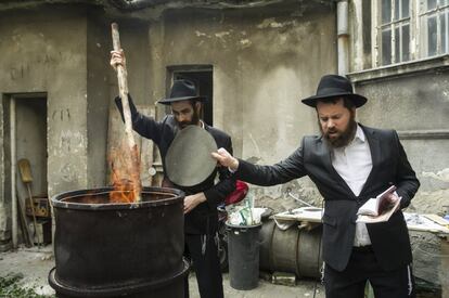 Hungarian Hasidic Jews burn leavened bakery product leftovers in final preparation for the Passover holiday in the courtyard of the Kazinczy street mikveh in Budapest, Hungary, Monday, April 10, 2017. Jews are forbidden to eat leavened foodstuffs during the eight days of Passover, which celebrates the biblical story of exodus, the migration of the ancient Israelites from Egypt into Canaan. (Bea Kallos/MTI via AP)
