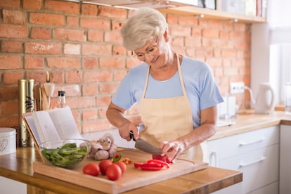 Senior woman cutting vegetables