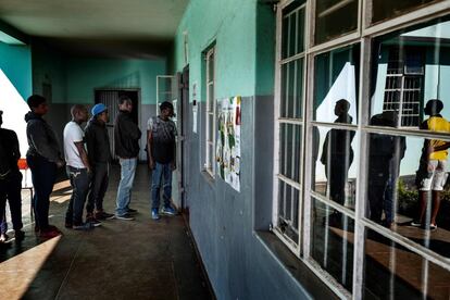 Los votantes hacen cola en una mesa de votación en el popular distrito de Harare, en Mbare.