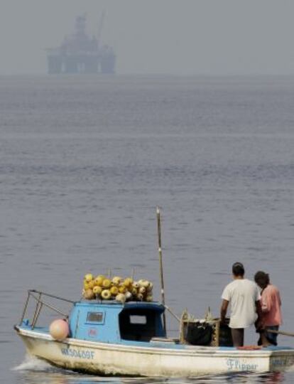 Two Cuban men fish near Repsol&#039;s platform in January.