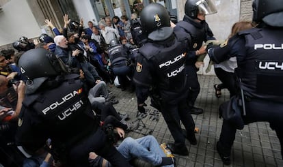 Police break up a group of voters on October 1 in Barcelona.