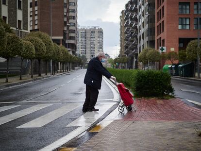 Un hombre regresa a su domicilio con la compra durante el Sábado Santo en Pamplona.