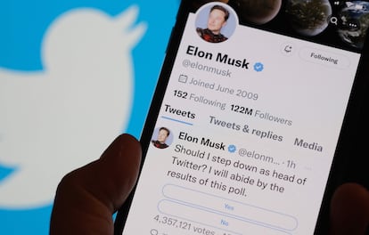 This photo illustration taken on December 18, 2022 in Los Angeles shows a phone displaying Elon Musk's Twitter page where he is conducting a survey about his future as the head of the company.