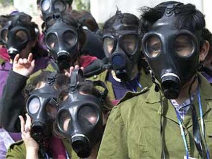 Estudiantes israelíes, con máscaras antigás, ayer, durante un simulacro de ataques químicos en Or Yehuda.