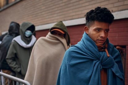 Migrants wait in the cold as they look for a shelter outside a Migrant Assistance Center at St. Brigid Elementary School on Wednesday, Nov. 29, 2023, in New York. (AP Photo/Andres Kudacki)