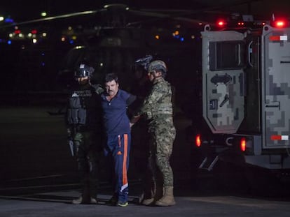 Two soldiers escort “El Chapo” Guzmán.