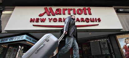 Un turista cruza por delante de la fachada de un hotel Marriott en Nueva York.
