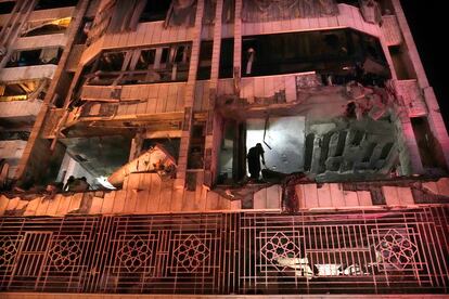 A rescue worker inspects an apartment hit by an Israeli airstrike in Beirut early Thursday.