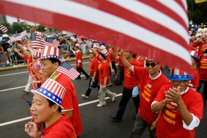 Tang De Wong, lower left, and other members of the Chinese Benevolent Association march in an Independence Day parade in Philadelphia, July 4, 2008.